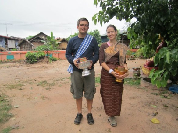 Bringing alms to a temple in Laos